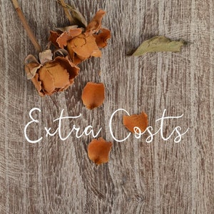 May include: Dried rose petals scattered on a wooden surface with the text "Extra Costs" written in white.