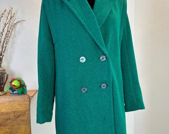 May include: A green corduroy double-breasted blazer with four large buttons. The blazer is on a mannequin and has a slightly oversized fit.