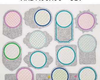 May include: Set of 10 felt mug rugs with different embroidered designs. The designs include circles, squares, and rectangles with various patterns. The mug rugs are gray with a white background and colorful embroidery.