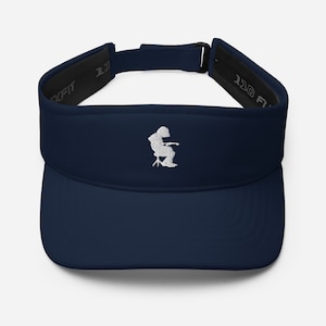 May include: A navy blue visor with a white embroidered design of a person sitting in a chair. The visor has a black adjustable strap with the text "110 FIT" on it.
