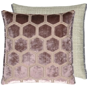 May include: A decorative throw pillow with a geometric pattern of hexagons in a light purple color. The pillow has a light green backing.