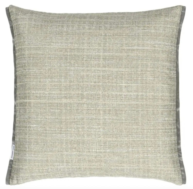May include: A gray throw pillow with a subtle textured pattern and a gray border.
