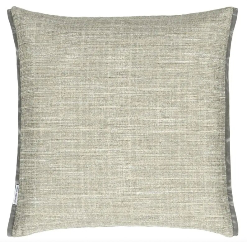May include: A gray throw pillow with a subtle textured pattern and a gray border.