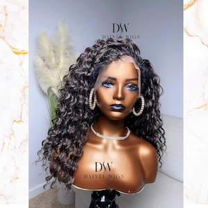 May include: A black curly human hair wig on a mannequin head. The wig has a lace front and is styled in loose curls. The mannequin is wearing gold hoop earrings and a silver necklace. The text "DSW DAINTY WIGS" is visible on the mannequin's chest.