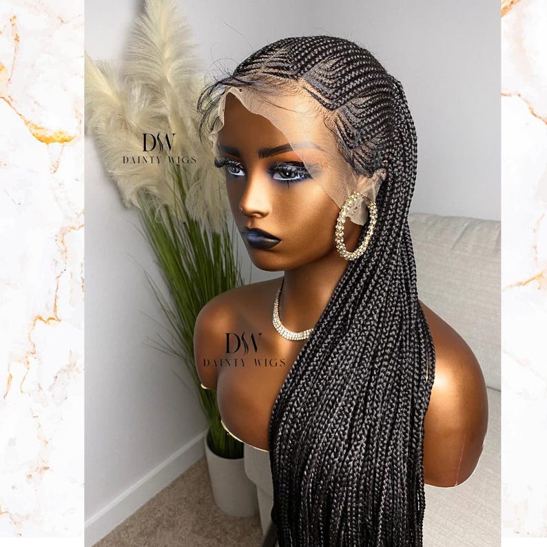 May include: A black braided wig with a lace front is displayed on a mannequin head. The wig features intricate cornrow patterns on top and long, flowing braids. The mannequin is wearing gold hoop earrings and a diamond necklace. The brand name "DAINTY WIGS" is visible.