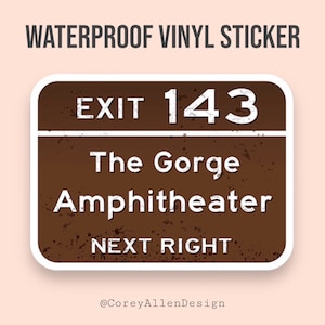 May include: Brown and white waterproof vinyl sticker with a distressed look. The sticker features a sign that reads "EXIT 143 The Gorge Amphitheater NEXT RIGHT".