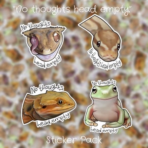 May include: A sticker pack featuring four different designs. Each sticker depicts a different animal with the text "No thoughts head empty". The animals are a gecko, a snake, a bearded dragon, and a frog. The stickers are printed on white paper with a glossy finish.