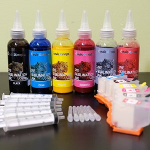 May include: A collection of dye sublimation ink bottles in black, cyan, yellow, magenta, purple, and red, with syringes and a printer cartridge. The bottles have white caps and labels with the "InkXpro" logo and the words "Dye Sublimation Ink".