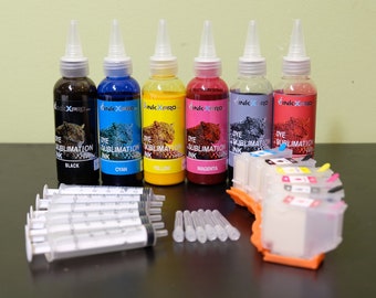 May include: A collection of dye sublimation ink bottles in black, cyan, yellow, magenta, purple, and red, with syringes and a printer cartridge. The bottles have white caps and labels with the "InkXpro" logo and the words "Dye Sublimation Ink".