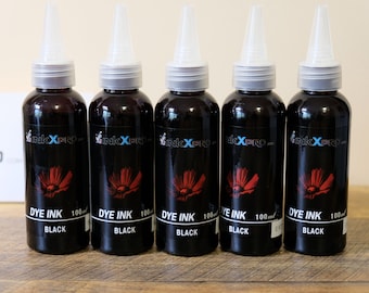 May include: Five black dye ink bottles with white nozzles. Each bottle has a red flower design and the text "DYE INK BLACK 100ml". The brand name "InkXPro" is also visible on the bottles.