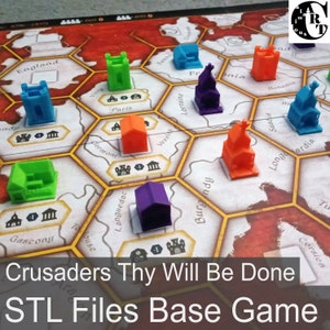 May include: A close-up of a game board featuring colourful 3D printed buildings. The board is labelled with the names of various European regions, including England, France, and Germany. The text "Crusaders Thy Will Be Done STL Files Base Game" is printed at the bottom of the image.