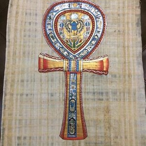 May include: Ankh symbol art print on papyrus. The ankh is a cross with a loop at the top, featuring intricate details in red, gold, blue, and green. The background is a light tan color.