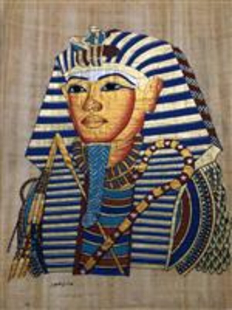 May include: A colorful papyrus painting depicts a pharaoh with a gold face, wearing a striped headdress and collar. The artwork features blue, gold, and red hues, with intricate details in the pharaoh's attire and accessories.