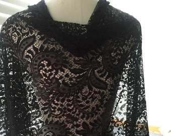 May include: Black lace fabric with a delicate floral pattern. The lace is sheer and has a soft, flowing texture.
