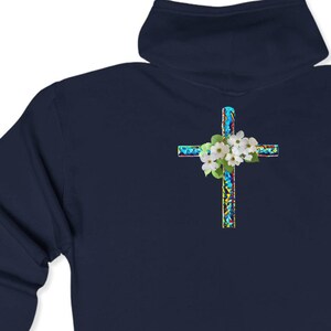 May include: Navy blue hooded sweatshirt with a cross design on the back. The cross is made of blue, green and yellow mosaic tiles with white flowers.