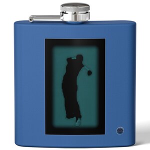 May include: A blue stainless steel flask with a golfer silhouette on the front. The flask has a silver cap and a small round logo on the bottom.