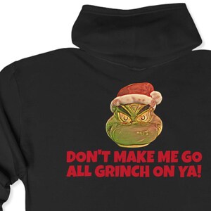May include: Black hooded sweatshirt with a green Grinch wearing a Santa hat and the text "Don't make me go all Grinch on ya!"