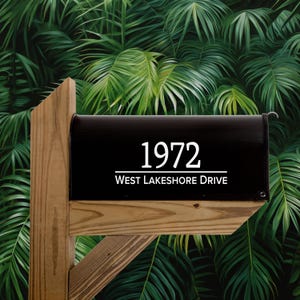 May include: Black mailbox with white lettering. The mailbox has the number 1972 and the street address West Lakeshore Drive.