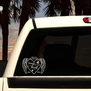 May include: White vinyl decal with a heart shape and angel wings. The text reads "Kevin McDaniel Your wings were ready but my heart was not 1961 2019".