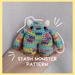 May include: A crocheted monster toy with a colourful patchwork design, white horns, and black eyes. The toy is being held in a hand with the text "STASH MONSTER PATTERN" below it.