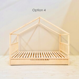 May include: A wooden bed frame with a house-shaped canopy and a pull-out drawer. The bed frame is made of natural wood and has a slatted base. Option 4.