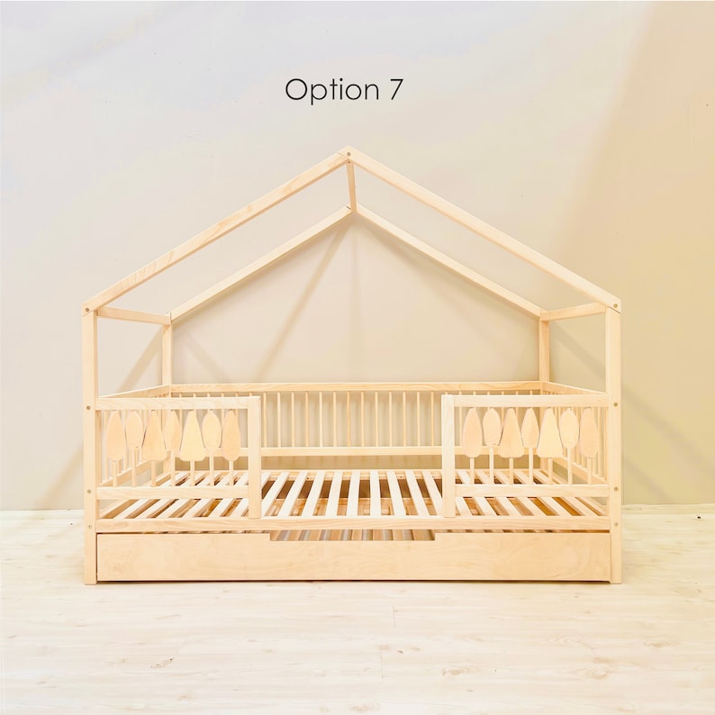 May include: A wooden toddler bed with a house-shaped frame and a pull-out drawer. The bed has a slatted base and a safety rail on one side. The bed is made of natural wood and has a light brown finish. Option 7.