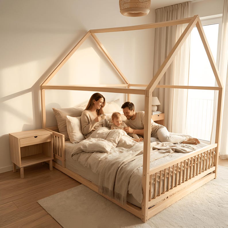 Family enjoying story time together on natural wood Montessori house floor bed, creating cozy family moments in a child-friendly bedroom