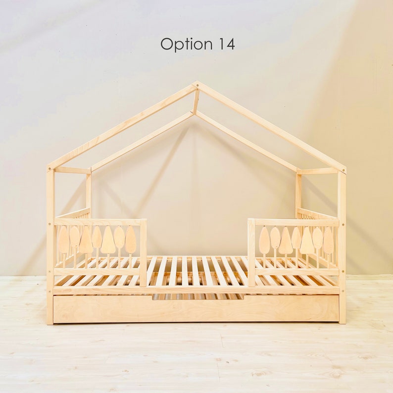 May include: A wooden bed frame with a house-shaped canopy and a pull-out drawer. The bed frame has a slatted base and decorative tree-shaped cutouts on the sides. The text "Option 14" is visible above the bed frame.