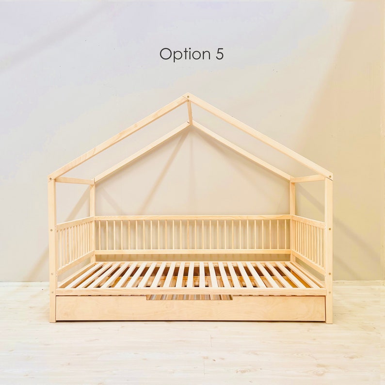 May include: A wooden house-shaped bed frame with a slatted mattress and a pull-out drawer. The bed frame is made of natural wood and has a simple, modern design. Option 5.