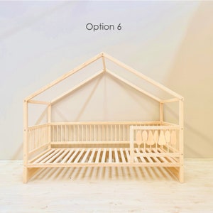 May include: A wooden house-shaped bed frame with a slatted mattress and a safety rail on one side. The bed frame is made of natural wood and has a simple, modern design. Option 6 is written at the top of the image.