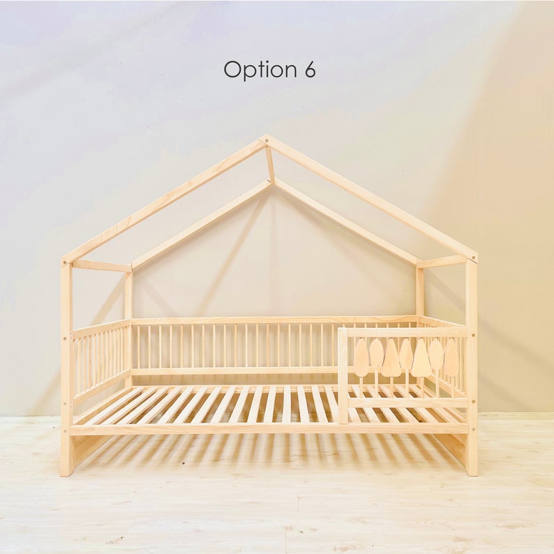 May include: A wooden house-shaped bed frame with a slatted mattress and a safety rail on one side. The bed frame is made of natural wood and has a simple, modern design. Option 6 is written at the top of the image.