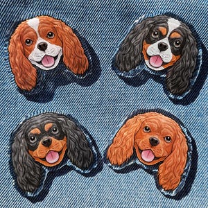May include: Four Cavalier King Charles Spaniel patches with different coat colors are displayed on a denim background. The patches feature detailed dog faces with open mouths and pink tongues. The patches are in shades of brown, black, and white.