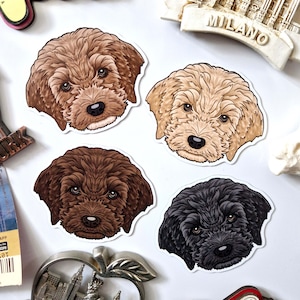 May include: Four illustrated dog head stickers. The stickers feature different dog breeds with brown, black, and blonde fur. The stickers are on a white background.