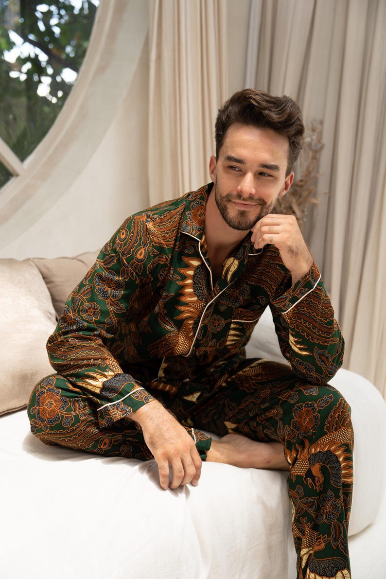 Puede incluir: Conjunto de pijama con estampado verde y marr&oacute;n con ribete blanco. La parte superior de manga larga y los pantalones presentan un dise&ntilde;o detallado y ornamentado. El pijama est&aacute; hecho de un material suave y c&oacute;modo.