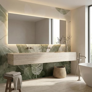 May include: A modern bathroom with a large rectangular mirror with a built-in light. The wall features a green and white leaf pattern. A light-colored stone vanity with chrome fixtures is below the mirror. A woven basket and a wooden stool are also present.