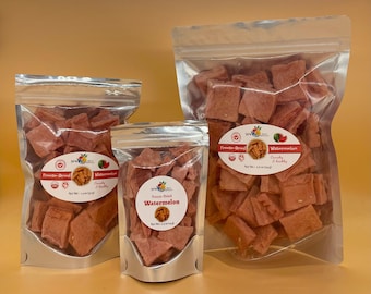 May include: Three clear stand-up pouches filled with freeze-dried watermelon chunks. The labels feature the text Freeze-Dried Watermelon, Crunchy & Healthy, and net weights of 1.5 oz, 0.5 oz, and 3.0 oz respectively, with fruit illustrations.