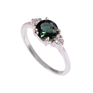 Natural green tourmaline solitaire ring in 925 sterling silver set inside a velvet ring display box.