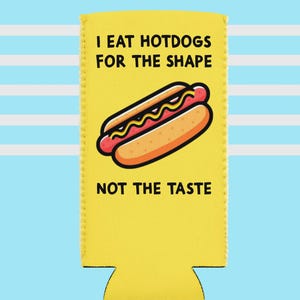 May include: Yellow beverage insulator with a cartoon hotdog illustration. The text reads "I EAT HOTDOGS FOR THE SHAPE NOT THE TASTE" in black capital letters. The background is blue and white striped.