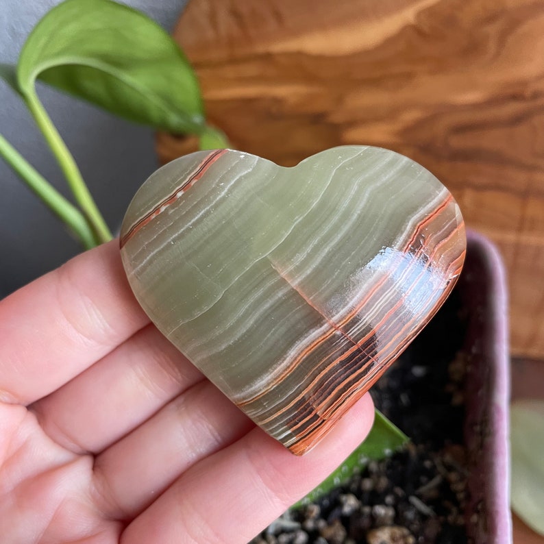 Dive into tranquility with a close-up view of our A Grade Large Green Onyx Heart. Immerse yourself in the soothing energy and premium quality of this exquisite crystal.