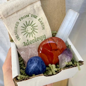 Mini Crystal Set Unveiled: Discover the beauty of our mini mystery box featuring crystals for cleansing, grounding, and healing. Shown including a selenite stick and palm stone.