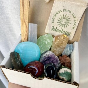 Inside the Medium Crystal Box: Unveil a mystical assortment of crystals and metaphysical tools, which may include palm stones and crystal clusters for your spiritual journey.