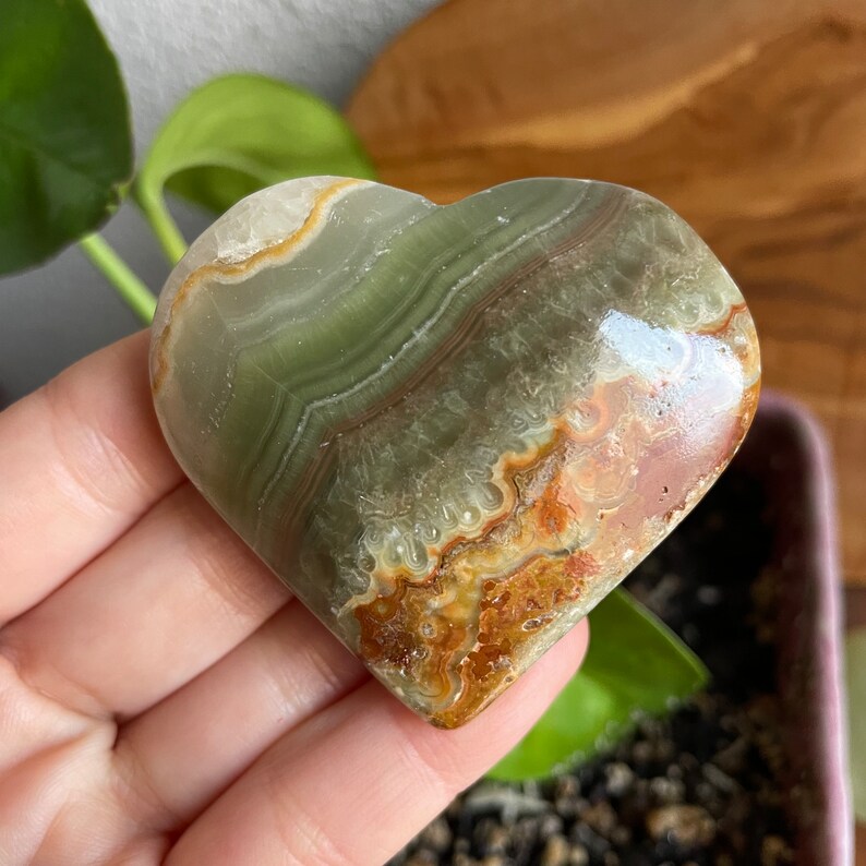 Create your sanctuary with the serene beauty of Green Onyx Hearts displayed individually. This photo showcases the crystal's ability to infuse harmony and balance into your space.