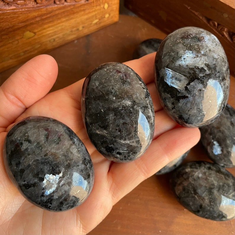 Dive into the mystic energy of Black Labradorite – Our Larvikite Palm Stones are a visual delight.