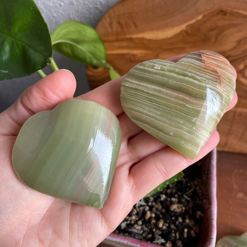 Explore the intricate patterns of our Green Onyx Heart in this captivating photo. A symbol of harmony and healing, this premium crystal radiates serenity and well-being.