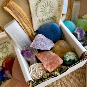 Small Mystery Crystal Box Potential Contents: Unbox a selection of tumbled and rough stones, a palo santo stick, and a crystal cluster. A beautiful mix of earth's natural treasures!