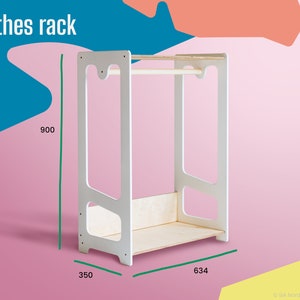May include: White clothes rack with a wooden bar and a shelf. The rack is 35 inches wide, 63.4 inches tall, and 900 millimeters high.