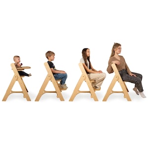 May include: Four wooden chairs of varying sizes, designed for different age groups. The first chair is a high chair with a tray, followed by three chairs suitable for older children and adults. The chairs are made of light-colored wood and have a simple, A-frame design.