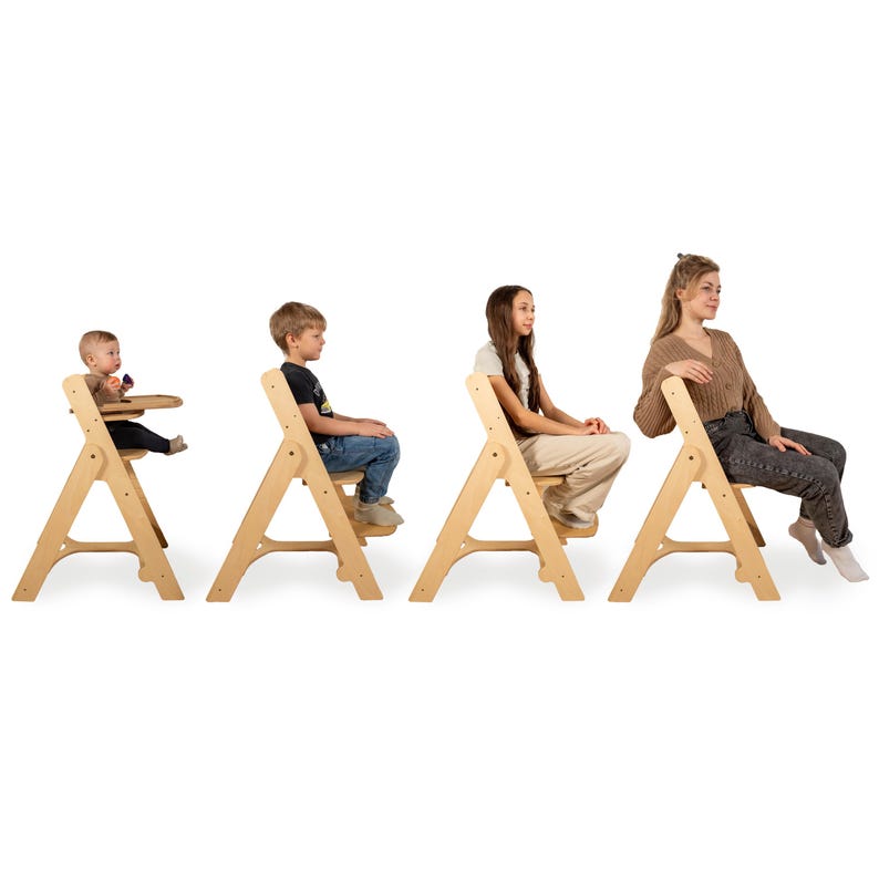 May include: Four wooden chairs of varying sizes, designed for different age groups. The first chair is a high chair with a tray, followed by three chairs suitable for older children and adults. The chairs are made of light-colored wood and have a simple, A-frame design.