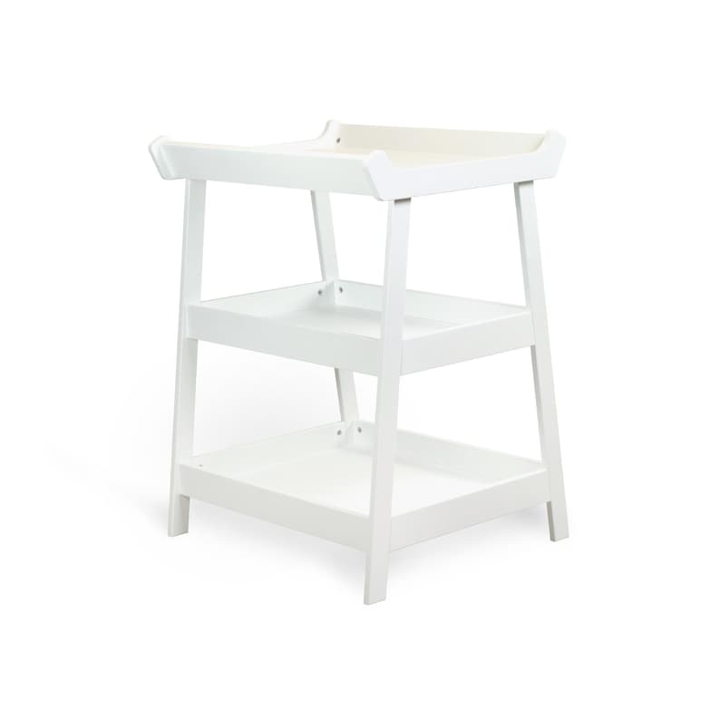 May include: A white wooden changing table with three tiers. The top tier has a raised edge, and the lower tiers are open shelves. The table is designed with a minimalist aesthetic and is suitable for a nursery.