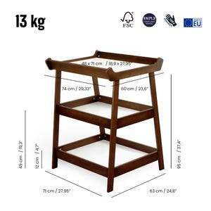 May include: A dark brown wooden changing table with dimensions of 27.95" x 24.8" x 37.4". The table has a top surface of 18.9" x 27.95" and includes two lower shelves. The frame is sturdy and features rounded edges.